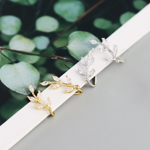 Macro detail of leaf-shaped ear cuffs with sparkling marquise-cut cubic zirconia crystals