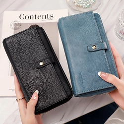 Litchi texture long wallets in black and fog blue held by hand for size reference