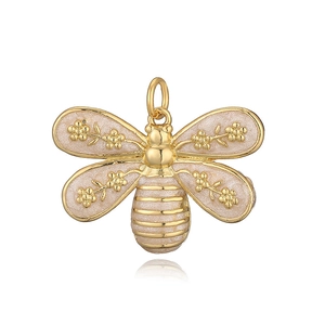 Detailed macro view of a golden bee pendant with pink glitter wings and tiny gold flowers