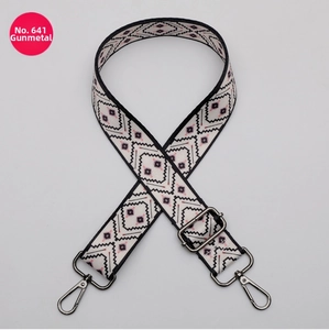 Close-up of ethnic geometric pattern bag strap with gunmetal swivel hooks and slider