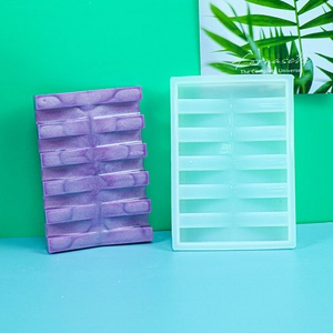 Detailed view of ten-slot rectangular silicone soap dish mold with purple resin sample
