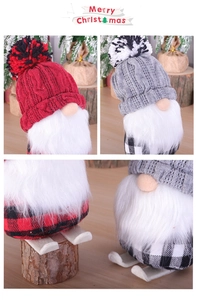 Detail of Christmas gnomes on wooden skis with knitted hats and plaid bodies