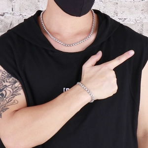 Hip hop silver stainless steel chain necklace and bracelet set worn by male model