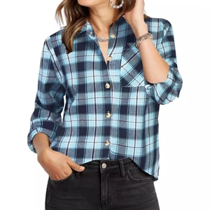 Close-up of blue and black plaid shirt featuring wood-style buttons and a chest pocket
