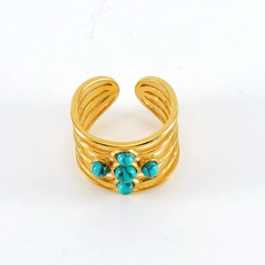 Detail view of gold adjustable wide band ring featuring four turquoise stone inlays