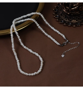 Detail of S925 sterling silver clasp and heart charm on natural freshwater pearl necklace
