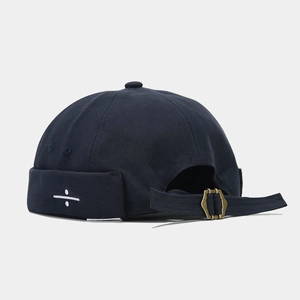 Detail of navy blue brimless hat with white division sign embroidery and metal buckle