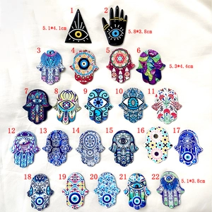 Set of 22 acrylic Evil Eye and Hamsa Hand pendants in diverse folk patterns for DIY jewelry