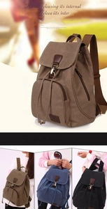 Close-up of vintage canvas backpacks with metal hook buckles and drawstring closure