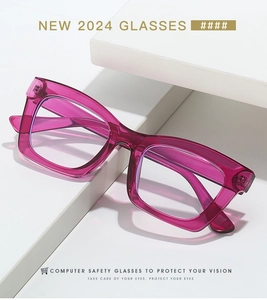 Close-up of translucent magenta square glasses frame with reinforced metal hinges on white decor