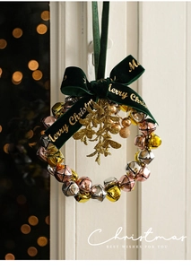 Christmas wreath with festive gold bells and dark green velvet Merry Christmas bow