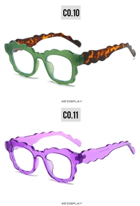 Detail of wavy frame sunglasses in translucent purple and green with tortoiseshell temples