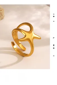 Detailed view of the gold starfish open ring with polished metal texture and star design