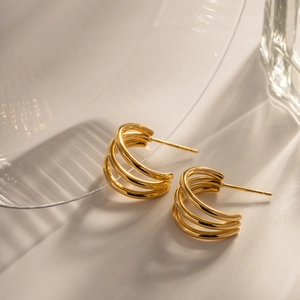 Detailed close-up of 18K gold-plated triple layer hoop earrings in stainless steel