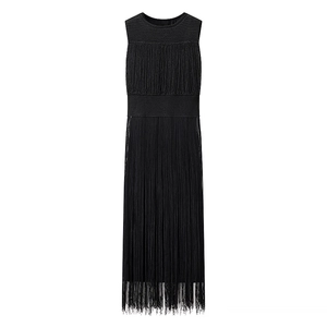 Detailed view of black sleeveless midi dress featuring dense fringe tassels on the skirt