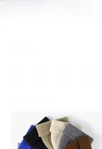 Detailed view of multiple knit beanies showing the thick ribbed texture and elastic weave