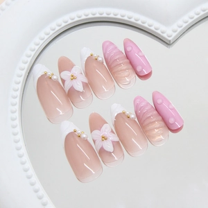 3D floral embossed press-on nails with pearls and pink gradient on almond shape