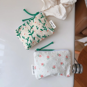 Detail of floral cotton mini coin purses with zipper closures and simple wish label