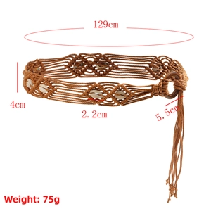 Detail of bohemian hand-woven belt with natural shells and a dark round buckle
