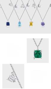 Macro shot of silver zodiac necklace featuring pear-cut colored gemstones and symbolic charms