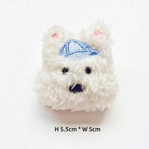 Detail view of Westie plush patch with blue embroidered hat, size 5.5cm by 5cm