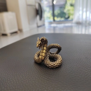 Retro brass dragon sculpture home decor with detailed scale texture on a black surface