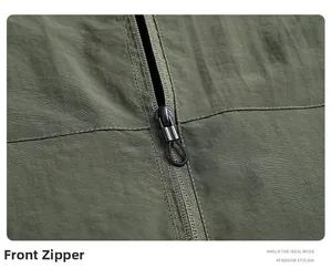 Detail of high-quality placket zipper on olive green outdoor jacket with textured fabric