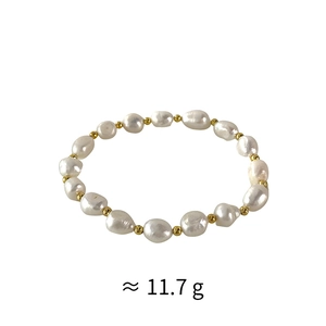 Macro view of irregular freshwater pearls and gold beads on elastic bracelet weighing 11.7g
