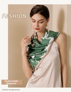 Close-up of abstract green leaf print on a silky twill scarf worn by a model