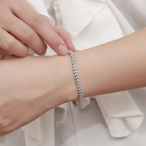 Elegant sterling silver tennis bracelet with shimmering moissanite stones on a wrist