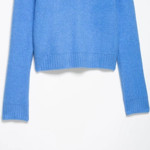 Sky blue knit long sleeve sweater with large lapel and ribbed cuff texture details
