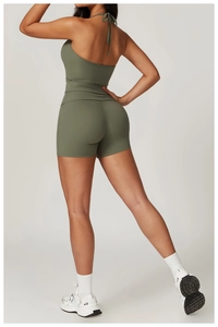 Detail view of olive green halter sports top and high waist shorts set on a model