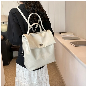 Minimalist beige backpack with geometric stitching and silver metal twist-lock shown on model