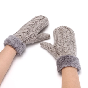 Detailed view of grey cable knit fingerless gloves with thick plush fur cuffs on wrist