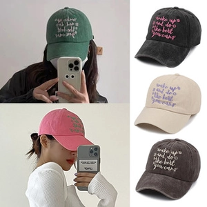Detailed close-up showing five colors of washed cotton baseball caps with embroidery