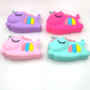 Four colorful unicorn silicone purses in purple, rose, pink, and mint green colors