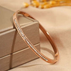 Macro shot of rose gold titanium steel bracelet with full square zircon inlay on satin