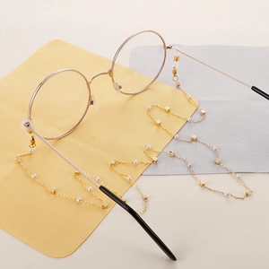 Gold stainless steel eyewear chain with white pearls and square charms on soft cloths