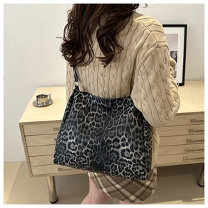 Rear view of a large leopard print tote bag styled with a minimalist outfit