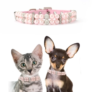 Close-up of pink double-row pearl pet collar with rhinestone ball and adjustable leather strap