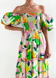 Detail of floral off-shoulder dress with smocked bodice and vibrant summer print