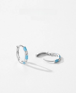 Detail of S925 sterling silver hoop earrings with blue enamel and sparkling zircon stones