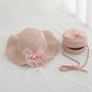 Close-up of pink straw hat and bag set with lace trim and cute bunny bow details