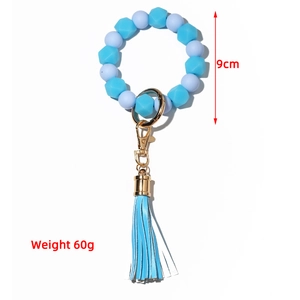 Luminous blue silicone beaded keychain with tassel and gold metal clasp, 9cm diameter