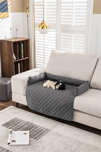 Close-up of grey quilted water-resistant pet sofa protector with integrated bolster on couch