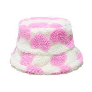 Detailed macro view of the soft pink heart pattern on thick faux lamb wool bucket hat