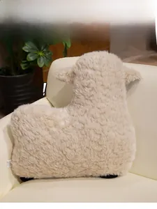 Gros plan d'un coussin mouton en peluche crème montrant la texture douce des poils