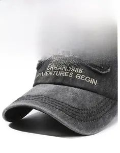 Detail of vintage washed denim cap with URBAN.1986 embroidery and distressed brim