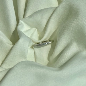 Close-up of S925 sterling silver band ring featuring a row of shimmering pavé zircons