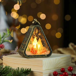 Detail of bronze Christmas lantern featuring Santa landscape and warm LED lighting